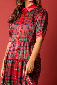 Detail View of Holiday Festivity Dress - Midi Length
Red Multi Tartan Plaid Print, Polyester, Classic and Flowy Fit with Slight Stretch, Puff 3/4 Length Sleeves with Plaid Printed Button on Cuffs. Collared Neckline, Button Front with Buttons Down Length of Front of Dress - Buttons are Plaid Print, Silky Finish, Elastic Waist, Tiered Style