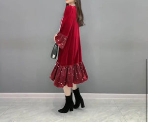 Side View of Red Color - Velvet Splendor Dress - Loose, Flowy Fit, Very Little Stretch - Ruffle on Sleeve Cuffs and Hem, Pearl Design Detail on Ruffle