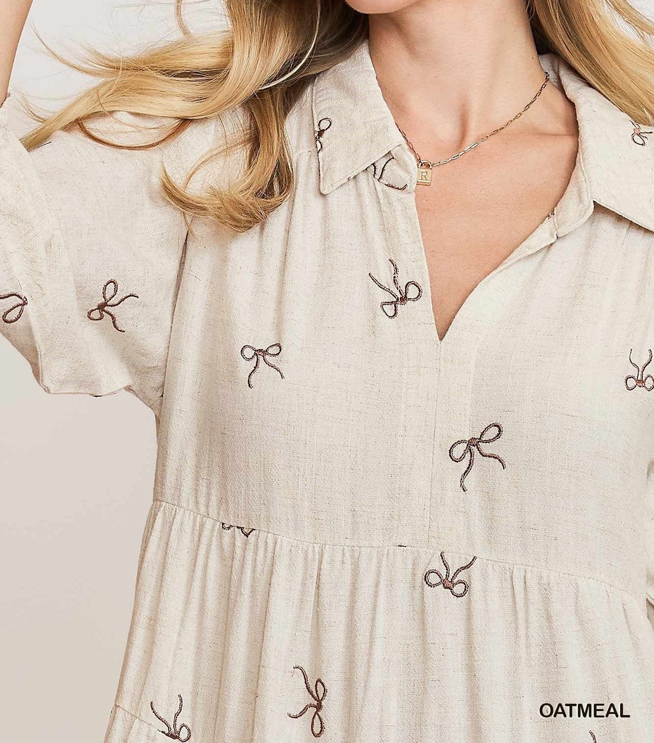 Detail View of Oatmeal Color - Bows Galore Dress - Midi Length - Tiered Style - 3/4 Length Sleeves - V-Neck Neckline - Bow Print Throughout