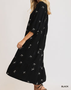 Side View of Black Color - Bows Galore Dress - Midi Length - Tiered Style - 3/4 Length Sleeves - V-Neck Neckline - Bow Print Throughout