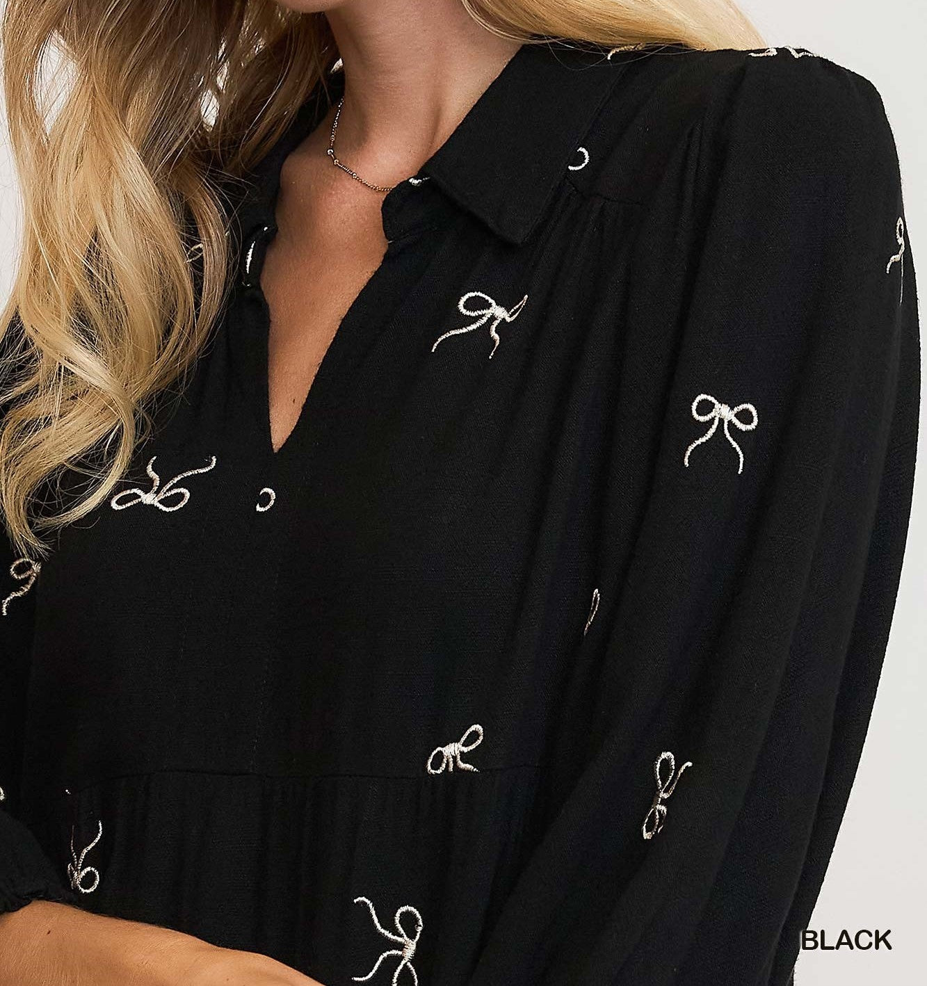 Detail View of Black Color - Bows Galore Dress - Midi Length - Tiered Style - 3/4 Length Sleeves - V-Neck Neckline - Bow Print Throughout