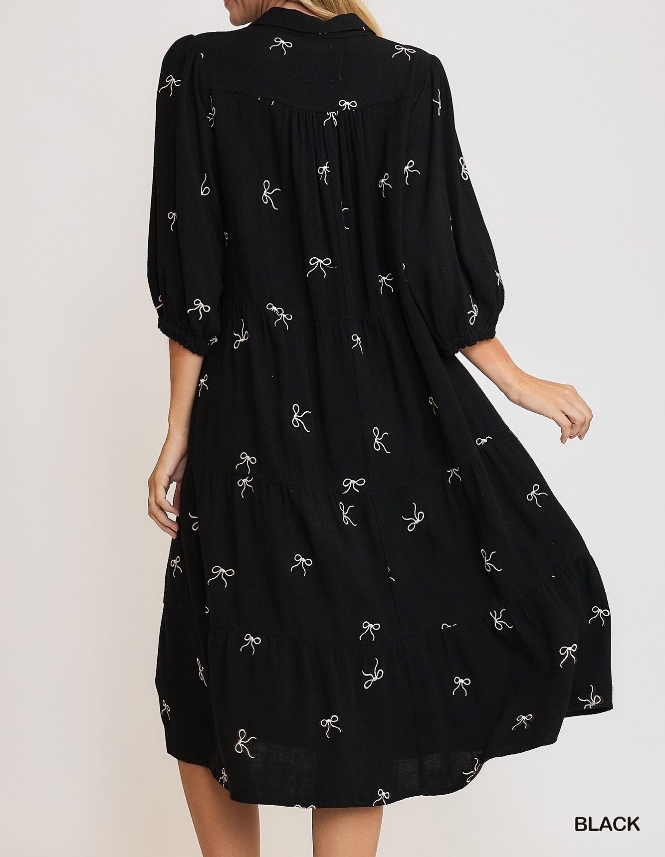 Back View of Black Color - Bows Galore Dress - Midi Length - Tiered Style - 3/4 Length Sleeves - V-Neck Neckline - Bow Print Throughout