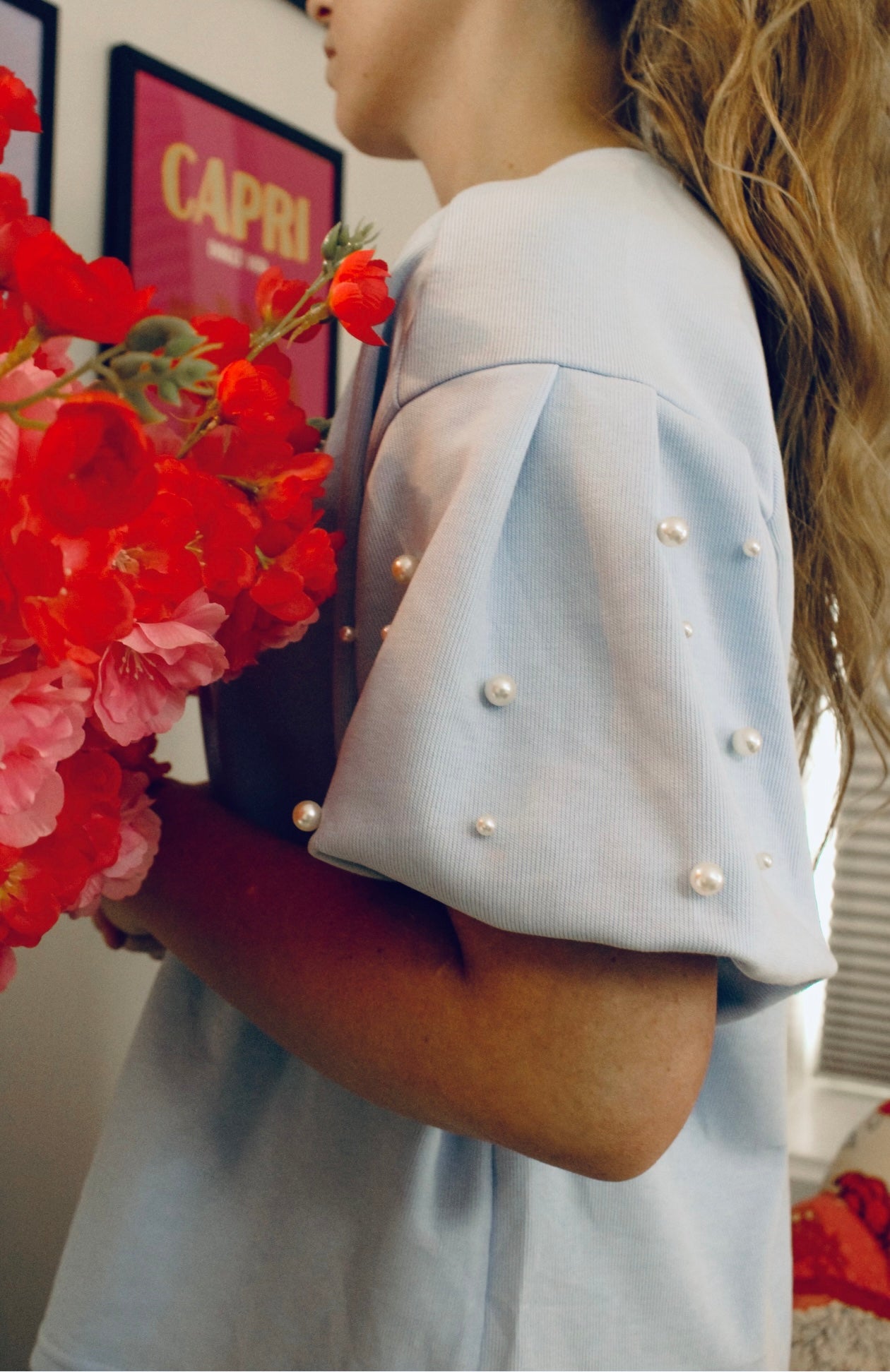 Darling in pearls in light blue knit top.