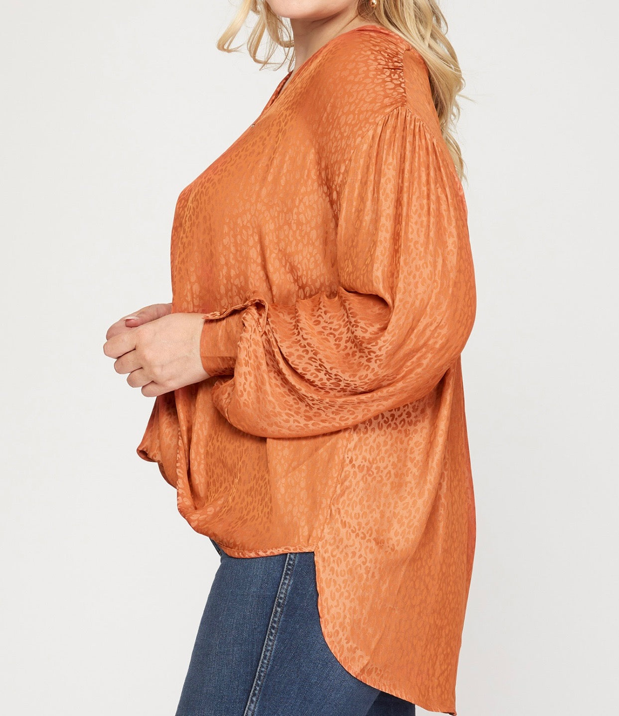 Side Detail View of Rust Orange Color - V-Neck Neckline, Long Dolman Sleeve Top with Surplice Crossover Bodice Style, Shiny Leopard Print, Wide Cuffs with Buttons on Sleeves, Side Slits on Bottom of Top