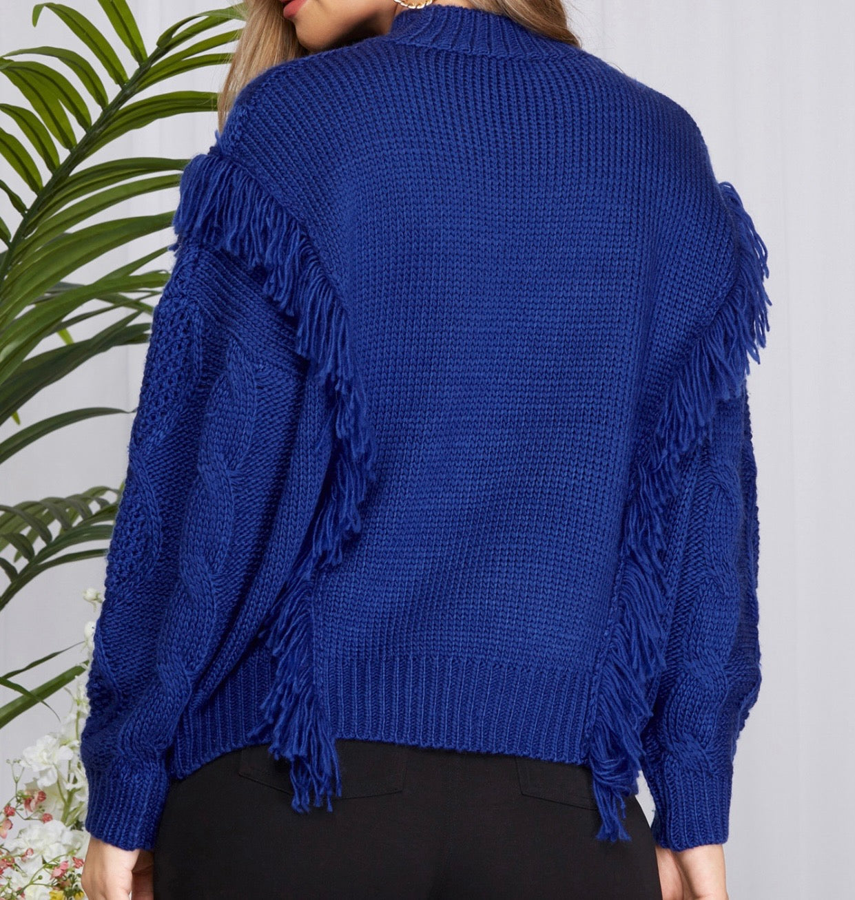 Back View of Cobalt Blue Color - Be Bold in Blue Sweater Top - Sweater Knit Fabric - Comfy and Relaxed Fit with Good Stretch - Cable Knit Style on Front, Simple and Classic Sweater Style on Back - High Neck Neckline
Long Sleeves with Ribbed Cuffs
Tassel/Fringe Detail Runs From Bottom of Sweater Up the Sides of Bodice, then Across Upper Arm Sleeve Down the Back of the Sweater on Each Side