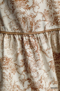 Detail View of Skirt on Brown Color - Christmas Landscape Dress - Midi Length - Long Balloon Sleeves with Elastic Cuffs - V-Neck Neckline - Landscape Pattern - Embroider Details Around Top of Bodice and Around Lower Portion of Skirt