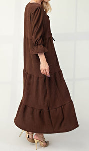 Side View of Brown Color - Tiered Maxi Dress with 3/4 Length Puff Sleeves and Ruffled Cuffs, Round Neckline with Keyhole Cutout and Detail Tying Bow