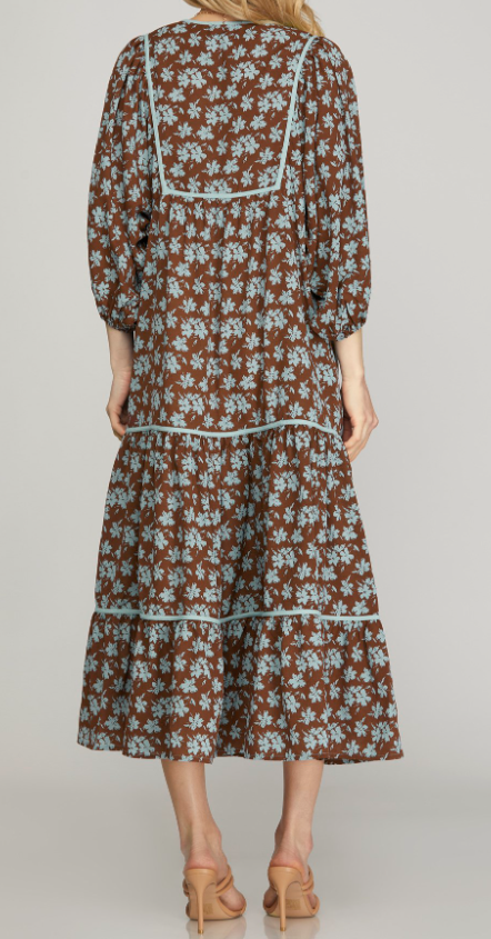 Back View of Brown Color - Midi Length, 3/4 Length Sleeves with Elastic Cuffs, Tiered Style, Brown with Soft Blue Floral Detail, Round Neckline with Keyhole Detail Opening with Tieable Tie