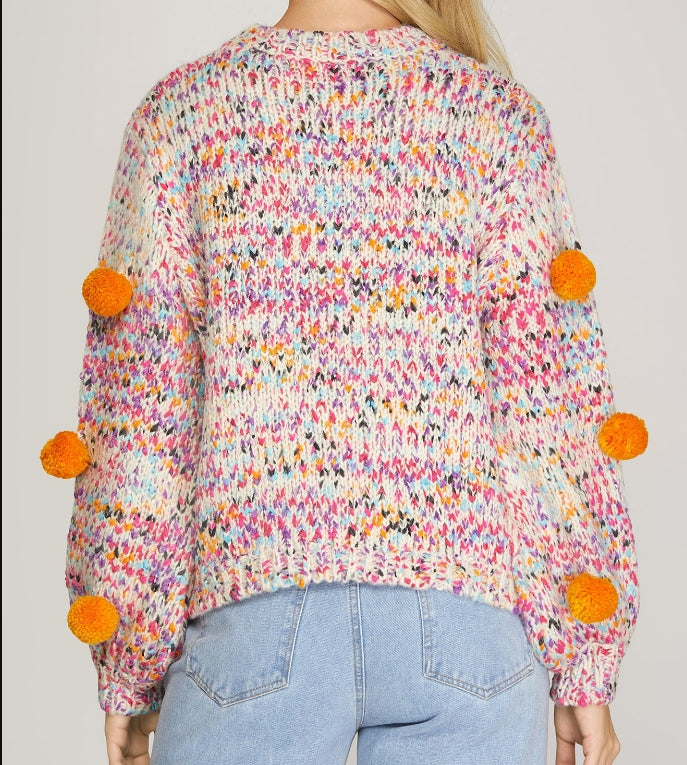 Back view of pom pom sweater in multi fall colors 