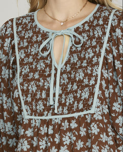 Detail View of Brown Color - Midi Length, 3/4 Length Sleeves with Elastic Cuffs, Tiered Style, Brown with Soft Blue Floral Detail, Round Neckline with Keyhole Detail Opening with Tieable Tie