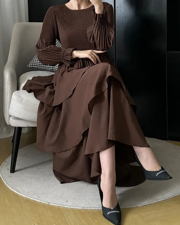 Sitting Front View of Chocolate Splendor Dress showing Pleated Detail and Ruffles in Brown Color