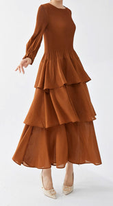 Side/Front View of Rust Colored Tiered One Size Dress with Pleated Detail and Ruffled Skirt